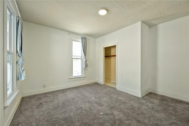 unfurnished bedroom featuring carpet floors and a closet