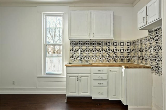 kitchen featuring dark hardwood / wood-style flooring, white cabinets, and sink