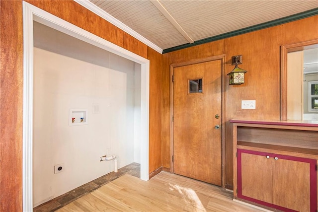 clothes washing area featuring light wood-type flooring, wooden walls, hookup for an electric dryer, washer hookup, and crown molding