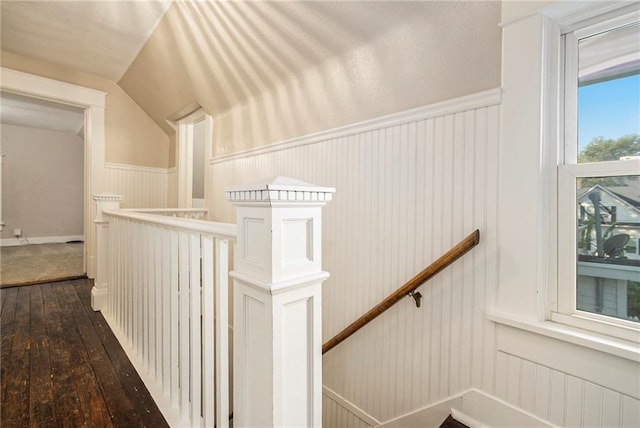 hallway featuring lofted ceiling and dark hardwood / wood-style flooring