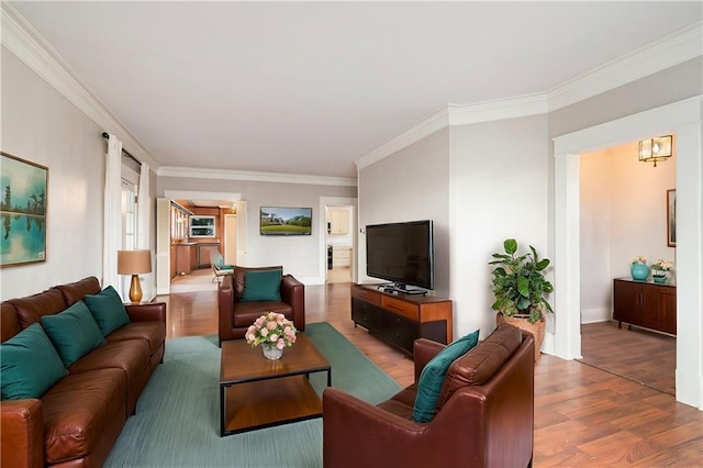 living room featuring crown molding and wood-type flooring