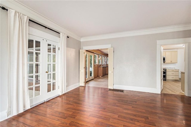 unfurnished room with french doors, ornamental molding, and light wood-type flooring