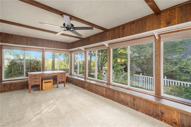 sunroom / solarium with ceiling fan and beam ceiling