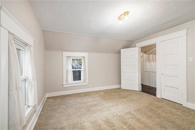 bonus room featuring carpet floors, a textured ceiling, and vaulted ceiling