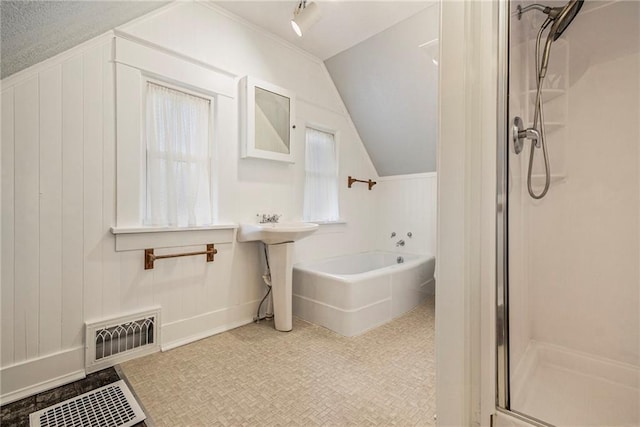 bathroom with plus walk in shower, vaulted ceiling, and wood walls