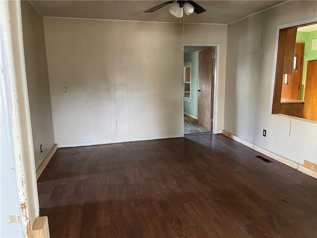 empty room with dark hardwood / wood-style floors and ceiling fan