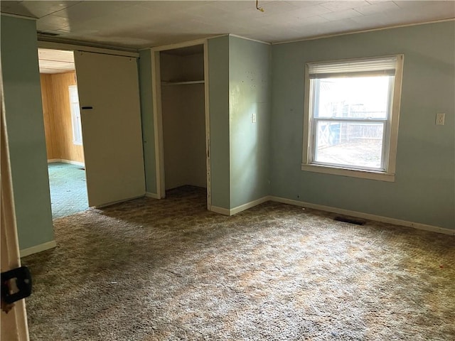 unfurnished bedroom with a closet and carpet