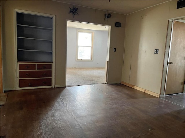 unfurnished room with wood-type flooring