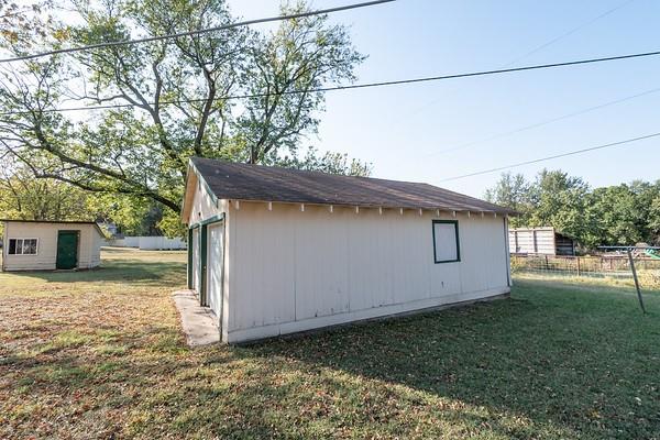 view of outdoor structure featuring a lawn