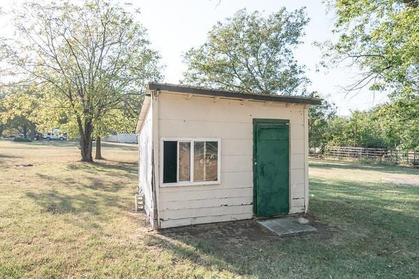 view of outdoor structure with a lawn