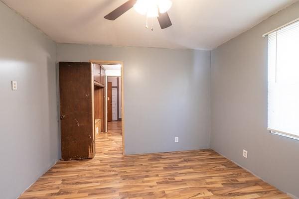 empty room featuring ceiling fan and light hardwood / wood-style floors