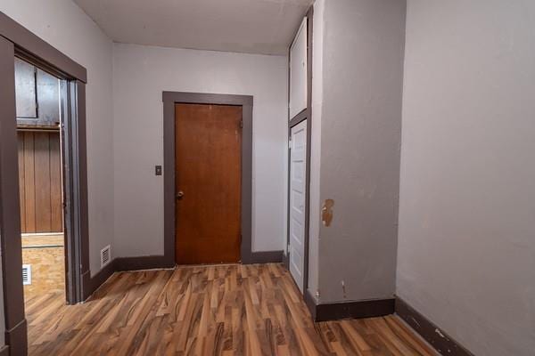 hallway with dark hardwood / wood-style floors