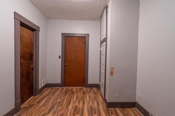 corridor featuring dark wood-type flooring