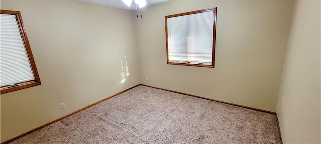 1516 E Lincoln St, Iola, KS 66749 - carpeted empty room with baseboards and a ceiling fan