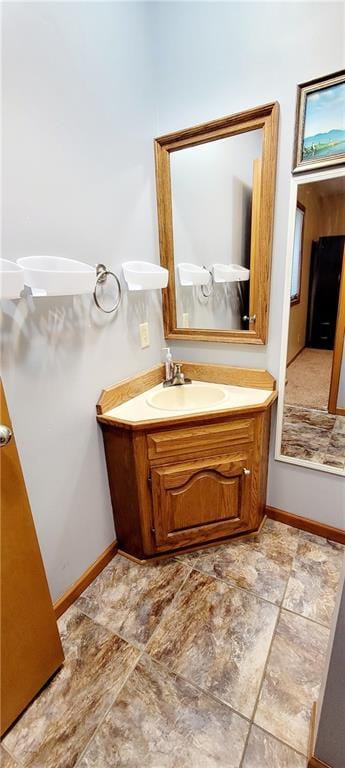 1516 E Lincoln St, Iola, KS 66749 - bathroom with baseboards and vanity