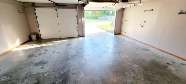 1516 E Lincoln St, Iola, KS 66749 - garage with baseboards and a garage door opener
