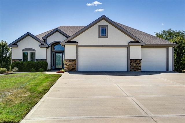 view of front of property featuring a front lawn and a garage