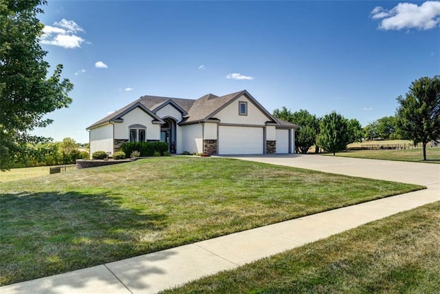 view of front of home with a front yard and a garage