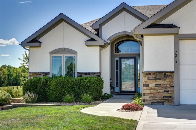 property entrance with a lawn and a garage