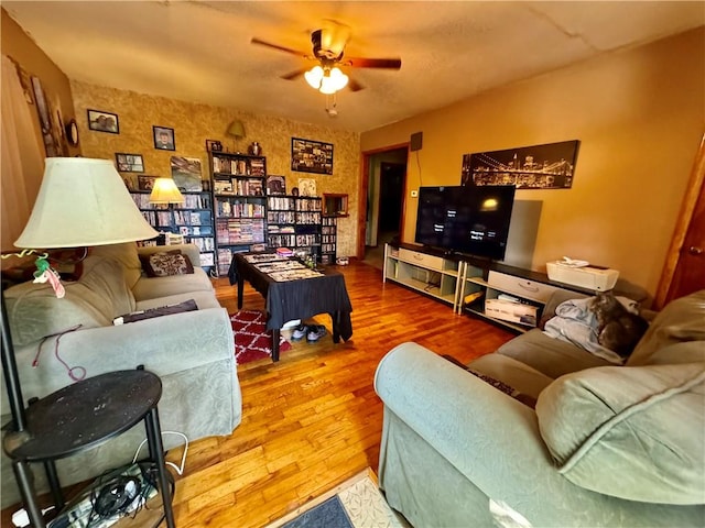 living room featuring wood-type flooring and ceiling fan