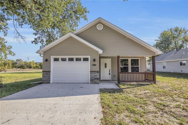 view of front facade with a garage, a porch, and a front lawn