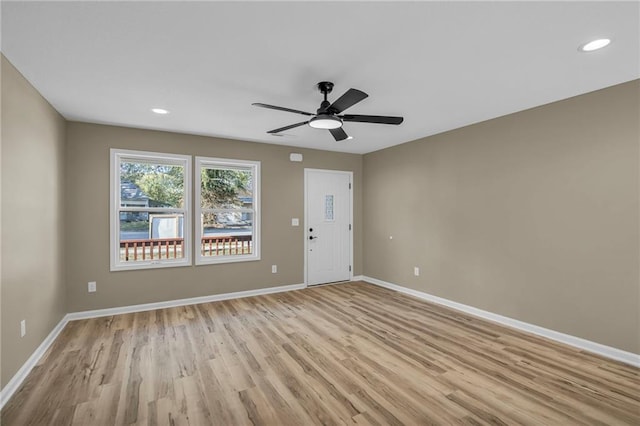 spare room with light wood-type flooring and ceiling fan