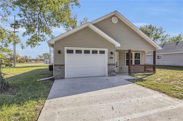 view of front of property with a garage, a front lawn, and covered porch