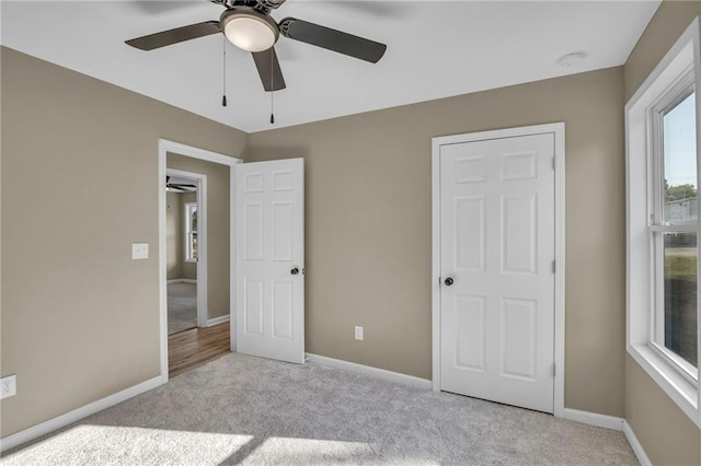 unfurnished bedroom featuring light carpet and ceiling fan