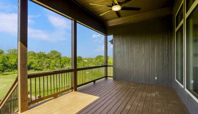 unfurnished sunroom featuring wood ceiling and ceiling fan