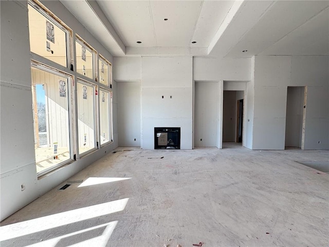 unfurnished living room with a high ceiling