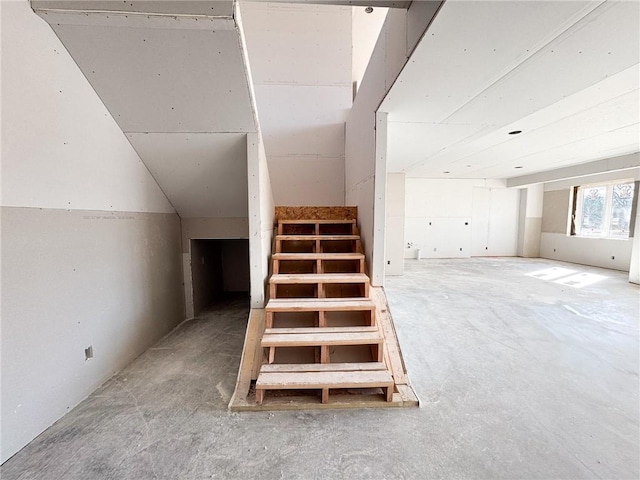 stairs featuring vaulted ceiling