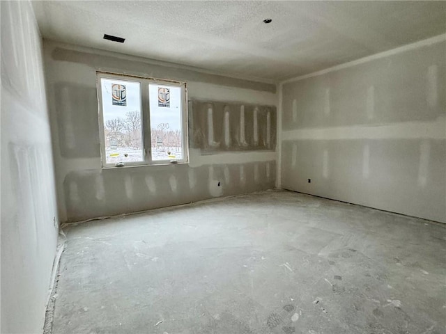 empty room featuring a textured ceiling