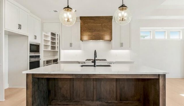 kitchen featuring white cabinets, stainless steel appliances, light countertops, and decorative light fixtures