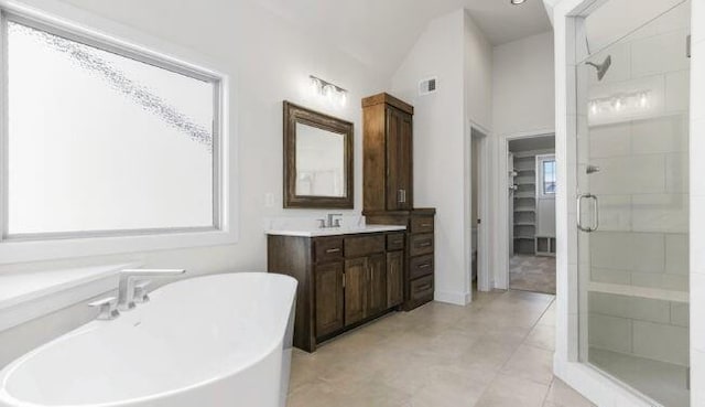 full bath with a stall shower, visible vents, a soaking tub, vaulted ceiling, and vanity