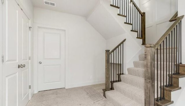 stairway with carpet floors, baseboards, and visible vents