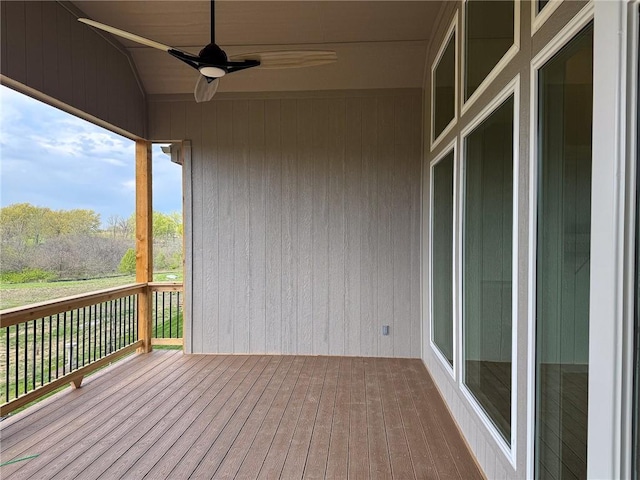 wooden deck featuring a ceiling fan