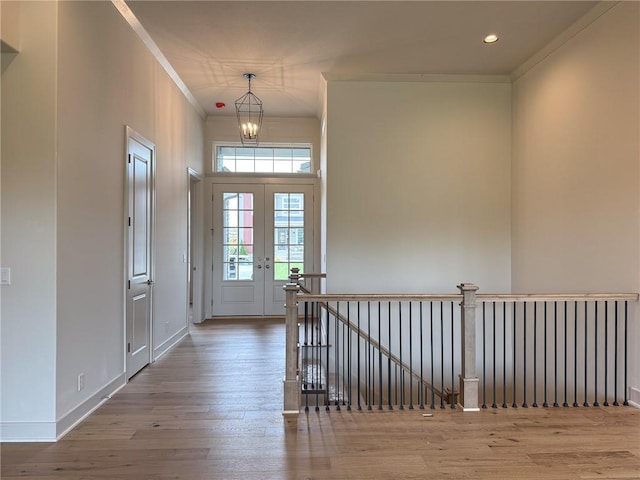 entrance foyer with a notable chandelier, recessed lighting, baseboards, wood finished floors, and ornamental molding