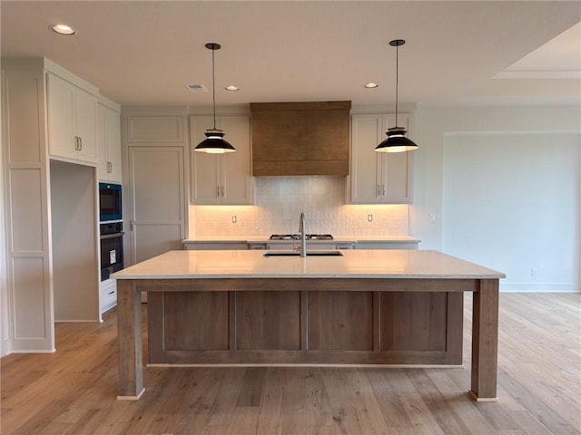 kitchen featuring recessed lighting, decorative backsplash, white cabinetry, and black appliances