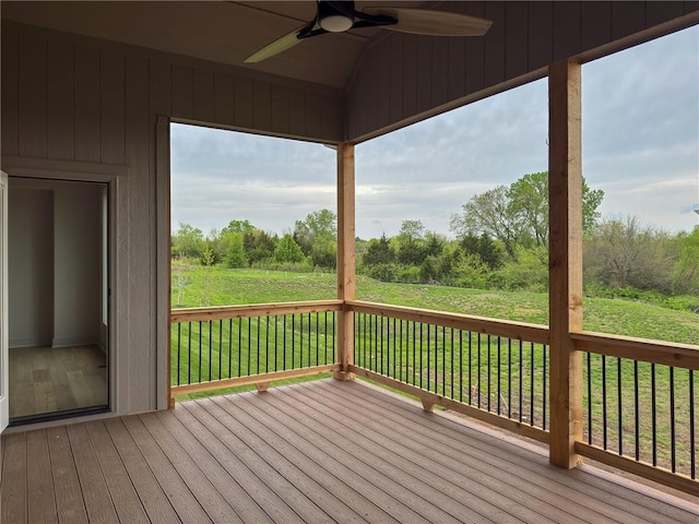 deck featuring a ceiling fan and a yard