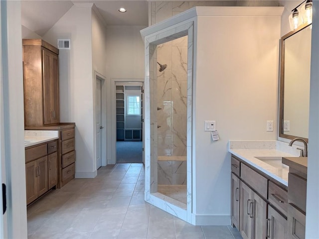 full bathroom with a marble finish shower, baseboards, vanity, and visible vents