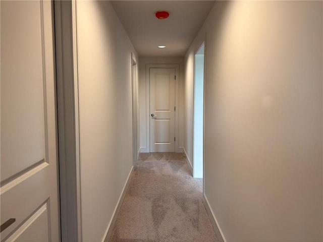 corridor with baseboards, light carpet, and recessed lighting
