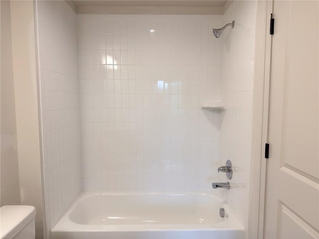 bathroom featuring shower / bathing tub combination and toilet
