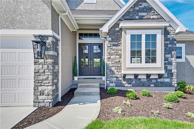 22063 W 100th Ter, Lenexa, KS 66220 - entrance to property with stone siding, french doors, a garage, and stucco siding