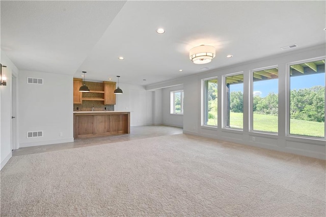 22063 W 100th Ter, Lenexa, KS 66220 - unfurnished living room with light colored carpet and recessed lighting