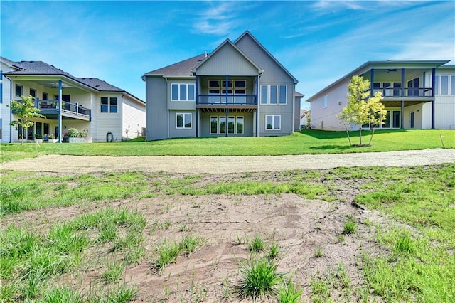 22063 W 100th Ter, Lenexa, KS 66220 - back of house featuring a balcony, a lawn, and a ceiling fan