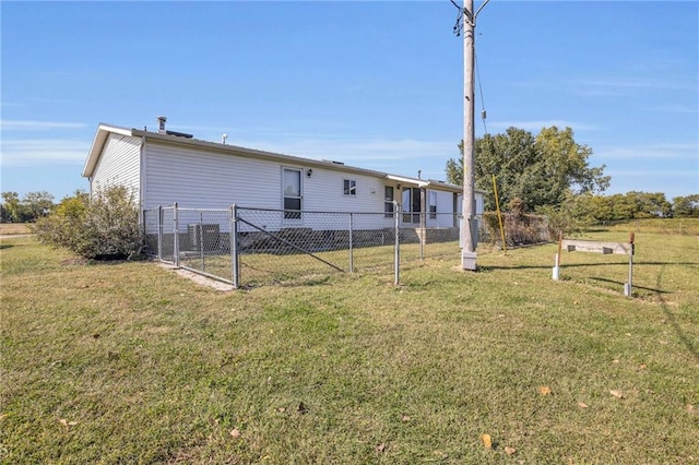 rear view of house featuring a lawn