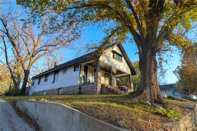 view of side of property with a porch