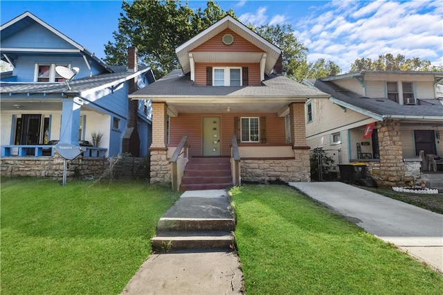 view of front of house with a front yard and covered porch