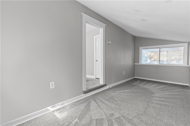 empty room with lofted ceiling and carpet