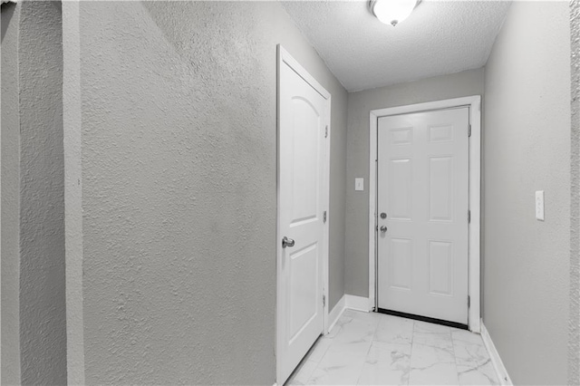 entryway featuring a textured ceiling